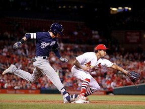 Milwaukee Brewers&#039; Nick Franklin, left, is safe at first as St. Louis pitcher Cardinals&#039; Carlos Martinez waits for the throw from Cardinals first baseman Matt Carpenter during the seventh inning of a baseball game, Tuesday, May 2, 2017, in St. Louis. Carpenter was charged with a fielding error on the play. (AP Photo/Jeff Roberson)