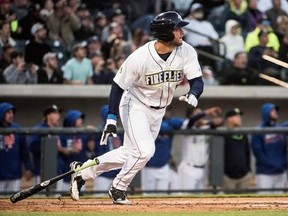 FILE - In this April 6, 2017, file photo, Columbia Fireflies&#039; Tim Tebow watches his home run during his first at-bat, during the team&#039;s minor league baseball game against the Augusta GreenJackets, in Columbia, S.C. After his first month in pro baseball, the New York Mets prospect and former Heisman winner seems to be getting more comfortable on the baseball field. (AP Photo/Sean Rayford, File)