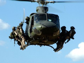 Troops from the Canadian Special Operations Regiment (CSOR) prepare to rappel from a CH-146 Griffon helicopter from 427 Special Operations Aviation Squadron (427 SOAS) during a training exercise near Kamloops, BC.