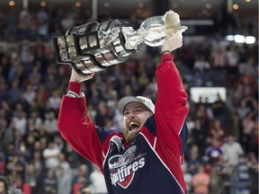 Windsor Spitfires center Aaron Luchuk raises the trophy after defeating the Erie Otters to win the Memorial Cup on May 28, 2017.