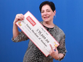 Donna Abraham poses with her big cheque at the OLG Prize Centre in Toronto.
