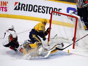 Andrew Cogliano, left, of the Anaheim Ducks and Mattias Ekholm (14) of the Nashville Predators crash the net during the second period in Game 3 of the NHL's Western Conference final at Bridgestone Arena on May 16, 2017 in Nashville, Tenn.