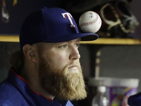 Texas Rangers starting pitcher Andrew Cashner balances a ball on his cap's bill during the fifth inning of the team's baseball game against the Detroit Tigers on May 19, 2017, in Detroit.