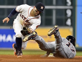 Detroit Tigers' Andrew Romine, right, steps on past Houston Astros second baseman Jose Altuve during the eighth inning of a baseball game, Thursday, May 25, 2017, in Houston.