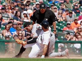 Baltimore's Ryan Flaherty tags out Detroit's Tyler Collins on an attempted steal in the eighth inning at Comerica Park on May 18, 2017 in Detroit.
