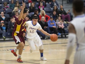 Kennedy's Ali Mansour is guarded by Catholic Central's Patrick Douangchantha in the WECSSAA AA basketball final at the St. Denis Centre on Feb. 19, 2017.
