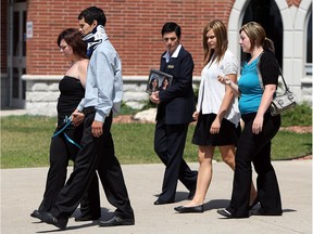 Angie Provost, formerly known as Angie Williams, left, and Andrew Williams walk behind a casket as it is taken to a waiting hearse following the funeral for Wynter and Brooklyn Williams at Visitation Parish near Belle River on June 23, 2012.