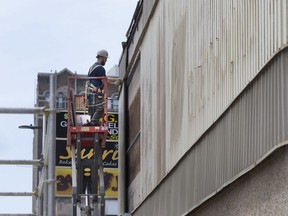 Crews have begun stripping the metal siding from the former bus station in downtown Windsor on May 23, 2017. The building is now owned by the University of Windsor.