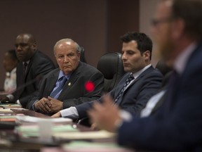 City councillors John Elliott, left, Ed Sleiman, and Fred Francis listen to Coun. Chris Holt during a debate on funding for the Open Streets event at a city council meeting, Monday. May 29, 2017.
