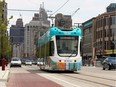 Woodward Avenue's QLINE streetcar rolls north on May 12, 2017 during its official launch in downtown Detroit as thousands lined up to take a free ride.