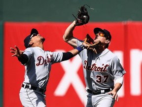Dixon Machado, left, and Jim Adduci of the Detroit Tigers go for a ball hit by Ryon Healy of the Oakland Athletics in the seventh inning at Oakland Alameda Coliseum on May 7, 2017 in Oakland, Calif.