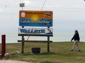 Colchester Harbour staff member Taylor Ross makes her rounds beside Colchester Beach on Lake Erie, Friday May 19, 2017.