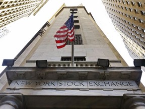 In this Nov. 13, 2015, photo, the American flag flies above the Wall Street entrance to the New York Stock Exchange.