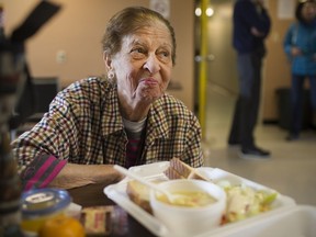 Susan Koshabe, a resident at 920 Ouellette Ave., enjoys her lunch on May 10, 2017. Non-profit group Feeding Windsor has launched the lunch program to improve nutrition and the sense of community in the building plagued by crime and violence.