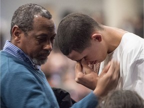 Ilies Soufiane, 15-year-old son of victim Azzeddine Soufiane, is consoled during a ceremony for three of the six victims of the Quebec City mosque shooting on Feb. 3, 2017 in Quebec City.