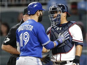 Toronto's Jose Bautista exchanges words with Atlanta's catcher Kurt Suzuki after hitting a home run during the eighth inning of a baseball game on May 17, 2017, in Atlanta. The incident led to both benches and bullpens emptying onto the field for the second time in the game. Atlanta won 8-4.