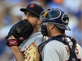 Detroit Tigers starting pitcher Justin Verlander talks with catcher John Hicks during the third inning of a baseball game against the Kansas City Royals at Kauffman Stadium in Kansas City, Mo., May 30, 2017.