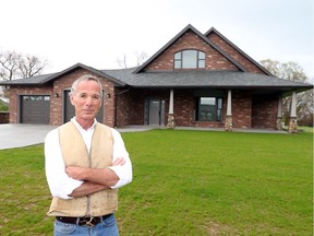 Homebuilder Gord Meuser stands at 10 Emily Ave., in Timbercreek Estates subdivision in Kingsville on May 1, 2017. Meuser has constructed this completely energy self-sufficient home.