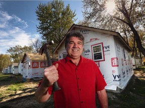 Dan Inverarity, president of the Kiwanis Club of Windsor, is shown in front of two new cabins under construction at the club's Sunshine Point Camp in Harrow. The camp welcomes kids from financially challenged families.