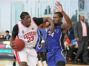 Windsor Express Shaquille Keith, left, protects the ball against Kitchener-Waterloo's Titans Tyrone Dickson in NBL Canada playoff action from Atlas Tube Centre Sunday May 7, 2017.