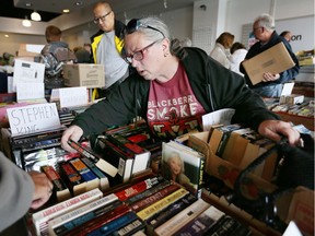 Stephen King fan Karen Whyte selects a few novels during the Raise-A-Reader book sale at Windsor Crossing on May 6, 2017.