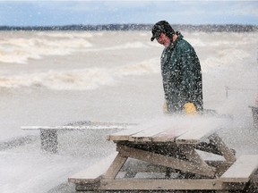 Property owner Chris Jakob watches as waves crash near his home on Point Pelee Drive in Leamington on May 2, 2017.