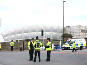 Police officers stand watch over Manchester Arena on May 23, 2017.