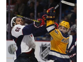 Jalen Chatfield, left, of the Windsor Spitfires and Kyle Maksimovich of the Erie Otters joust during their round-robin match  on Wednesday, May 24, 2017, at the Memorial Cup Tournament at the WFCU Centre in Windsor, ON.
