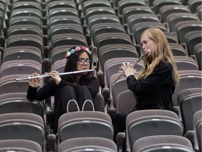 Sharbelle Torres, left, and Meeghan Ferguson warm up in the bleachers prior to a performance at St. Joseph's high school in Windsor on May 18, 2017.