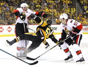 Ottawa's Dion Phaneuf, left, checks Pittsburgh's Jake Guentzel during second-period action of Game 2 of the NHL's Eastern Conference Final at PPG PAINTS Arena on May 15, 2017 in Pittsburgh.
