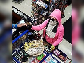 A security camera image of a masked female in a pink hooded sweater who robbed a convenience store in the 2700 block of Howard Avenue during the early morning hours of June 13, 2017.