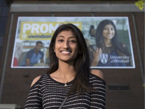 Rita Thamarappallil, 21, a fourth-year engineering student at the University of Windsor is pictured in front of a Promise poster in which she's featured.