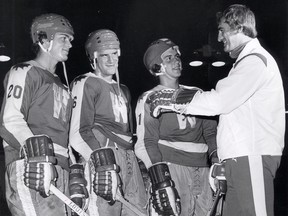 In this photo from  Sept. 2, 1977, Spitfires' coach Wayne Maxner, right, talks with team captain Joel Quenneville, centre, and top draft picks Jim Mellon, left, and John Kwant in the first day of training camp.