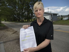 Gisele McLarty holds a notice from the Municipality of Leamington on May 30, 2017, notifying her that her bill will increase from $10,800 to $17,500 for sewer work outside her home on Point Pelee Drive.