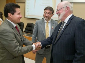 José Herlindo Velázquez Fernández (left), leader of Salvatierra, Mexico, shakes hands with Leamington Mayor John Paterson (right) on May 24, 2017. Alberto Bernal, Consul of Mexico in Leamington, looks on.