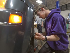 Ewan Wilson, 14, from Mill Street public school, works in the auto shop during a trades symposium at St Clair College, May 17, 2017.