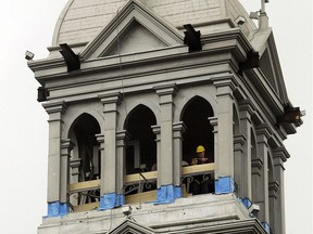 Workers atop Ste. Anne's church in Tecumseh on Oct. 26, 2007, prepare for the removal of the damaged spire and belfry.