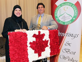 Honoured award recipients Amney Behiry, left, of AnNoor School and Patrick Hickson, principal of Holy Names Catholic High School, at the Windsor Islamic Council's 6th Annual Appreciation Dinner at the Ciociaro Club of Windsor. Behiry won the Lifetime Community Service Award while Holy Names won the Institutional Friend of the Year Award.  Both recipients posed in front of an impressive Canadian flag made of carnations which went well with the theme of the evening - Marking Our Celebrations of Canada 150.