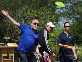 Tecumseh Mayor Gary McNamara throws a disc during a grand opening on May 27, 2017, for Tecumseh's Disc Golf Course at the Lakewood Park.