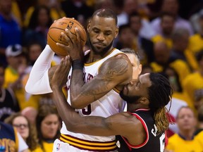 LeBron James of the Cleveland Cavaliers fights off the defence of DeMarre Carroll of the Toronto Raptors during the first half of Game 1 of the NBA Eastern Conference semifinals at Quicken Loans Arena on May 1, 2017 in Cleveland.