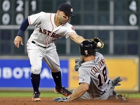 Detroit Tigers' Tyler Collins, right, is tagged out by Houston Astros second baseman Jose Altuve while attempting to steal second during the fifth inning of a baseball game, Monday, May 22, 2017, in Houston.