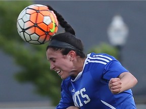 Emma Collins of St. Anne jumps in the air to head a ball during the WECSSAA girls' AAA soccer final against Villanova.