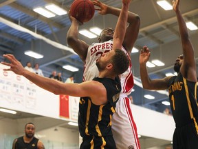 Windsor's Shaquille Keith shoots between London's Garrett Williamson, left, and Kyle Johnson during their NBL of Canada playoff game on May 18, 2017, at the Atlas Tube Centre Arena in Lakeshore.