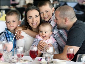 New mom Amanda Kaschak, holds her daughter Ava, 7 months old, centre, while getting hugs from nephews Kristopher, 8, Kooper, 5, and her husband Brandon Kaschak, right, during a Mother's Day brunch at St. Clair College Centre for the Arts Sunday May 14, 2017.