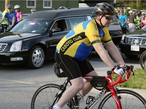 Ride leader Troy Whittle slowly cycles past two funeral hearses on Wyandotte Street East during Windsor's ninth annual Ride of Silence, May 17, 2017.