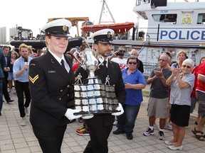 The Memorial Cup arrives at Windsor's Dieppe Park aboard Canadian Coast Guard vessel Constable Carriere on May 18, 2017. In photo, Leading Seaman Jeanette Giroux, left, and Leaking Seaman Hash Sameen, both of the Royal Canadian Navy, carry the cup through Dieppe Park. Hundreds of hockey fans joined the party, including members of CHL teams playing for the cup, who were watching from a balcony at St. Clair College Centre for the Arts.