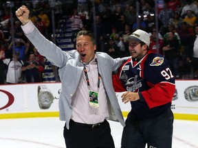 Windsor Spitfires general manager Warren Rychel and player Jeremy Bracco celebrate after the team defeated the Erie Otters 4-3 to win the Memorial Cup on May 28, 2017.