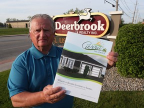 Mario DeMarco from Deerbrook Realty Inc.  displays a brochure on May 16, 2017, for a new development for Windsor.