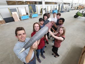 University of Windsor engineering team (from left:) Patrick Pomerleau-Perron,  Shannon Bosilac, Will Oudomsouk, Sam Randall, Michael Jyan,  Assistant Prof. Jeff Defoe, Jonathon Schrieber, Anthony Gudisey and Liza Dicecco display on May 17, 2017, their rocket entry in an upcoming competition in the United States.