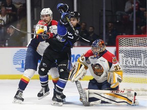 Saint John Sea Dogs Cole Reginato (37) gets tied up between Erie Otters Erik Cernak and goalie Troy Timpano during Memorial Cup action at the WFCU Centre in Windsor on May 22, 2017.